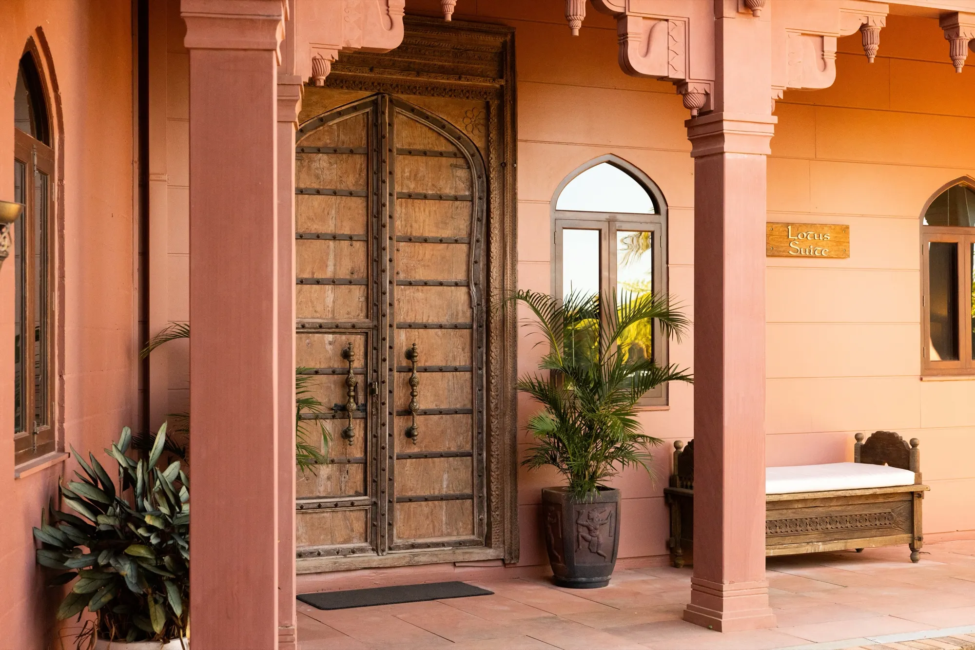 The Lotus House, the antique carved entrance door beneath the Lotus Suite sign