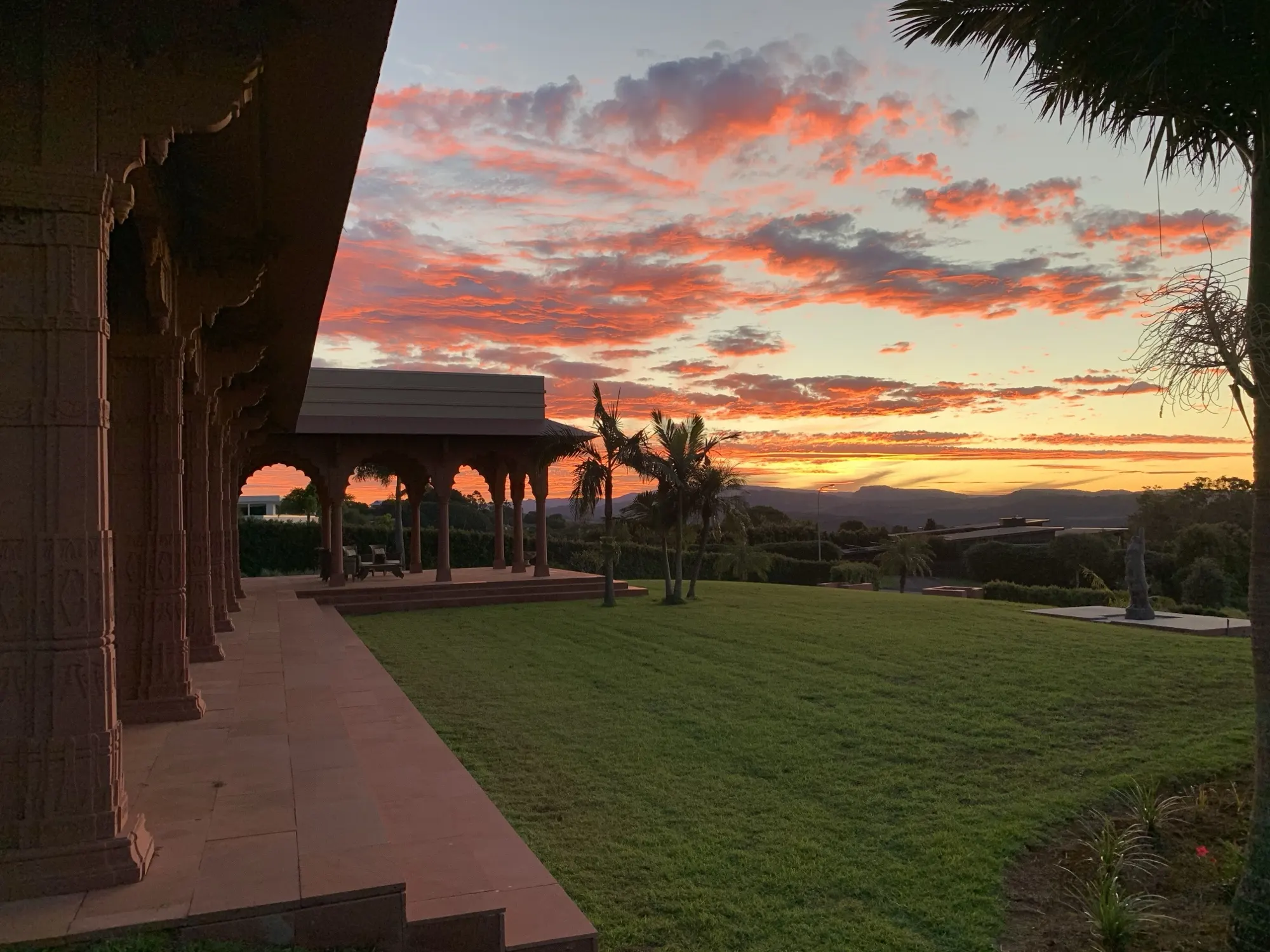 The Main Residence, the veranda beneath a pink sunset sky